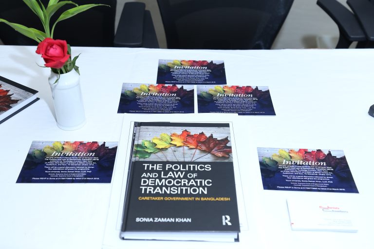 a book and invitation cards on the table